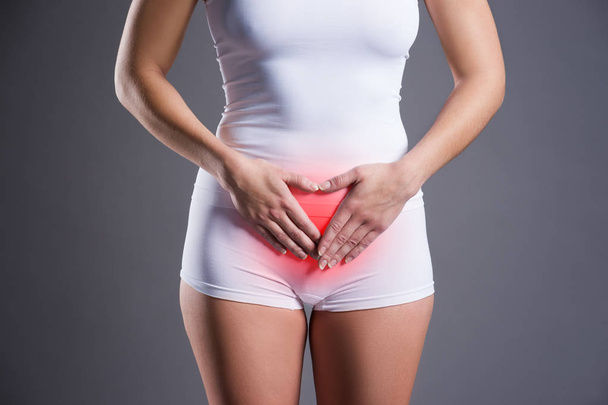 Woman with abdominal pain, stomachache on gray background - Φωτογραφία, εικόνα