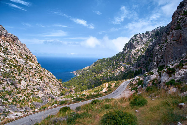Beautiful picturesque winding road of Spain summer coast and Mediterranean sea with tunnel. - Photo, image