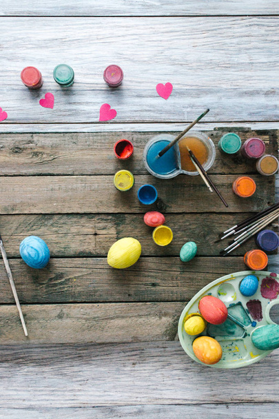 Easter eggs on a wooden background with paints - Photo, image