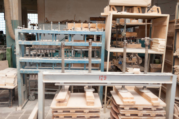 factory for the production of bent wood products. Tools for processing and gluing. Manufacture of guitars and stringed musical instruments. - Photo, Image