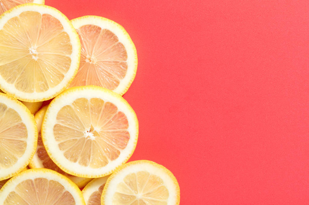 slices of lemon on pink background - Фото, изображение