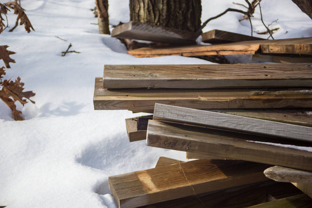Lumber in frozen woods surrounded by snow - Fotografie, Obrázek