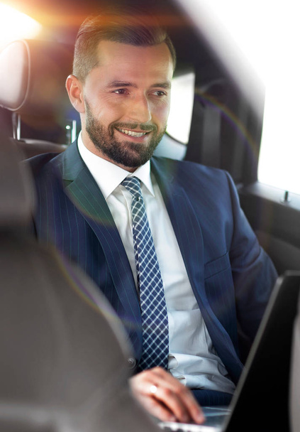 Portrait of a business man in the back seat of a car - Fotoğraf, Görsel