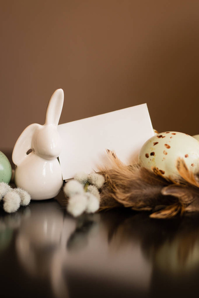 Small white rabbit figurine with easter eggs - Photo, Image