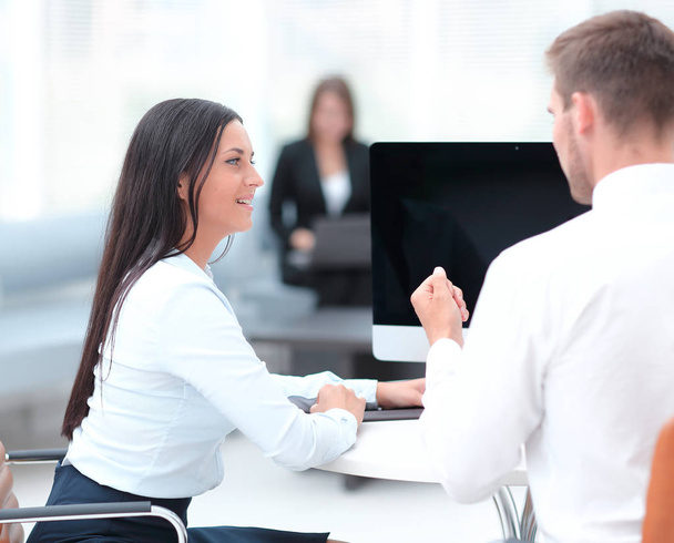 two successful employee talking sitting behind a Desk - Zdjęcie, obraz