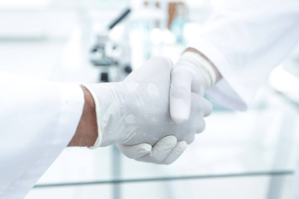 Handshake with white medical gloves - Foto, immagini