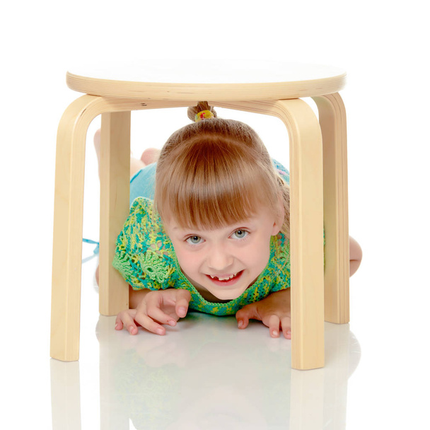 Little girl is sitting on a chair - Fotoğraf, Görsel