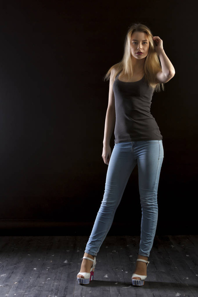 young woman with arms crossed isolated on black background - Fotografie, Obrázek