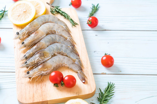 fresh shrimps or prawns raw on wooden board - Photo, image