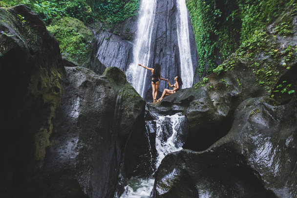 Two slim women near beautiful waterfall  - Zdjęcie, obraz