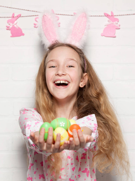 Child is holding a basket with Easter eggs - Fotografie, Obrázek