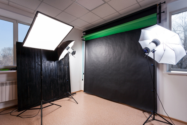 Photostudio with studio equipment: black, green, white background for photography, studio flashes, deflectors, Octoboxes - Photo, Image