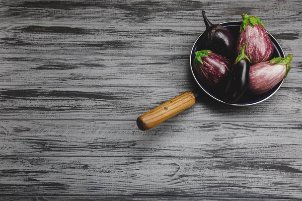 Fresh eggplant on a wooden background - Valokuva, kuva