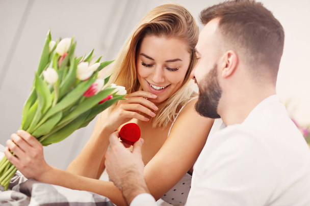 Adult attractive couple in bed with present - Photo, image