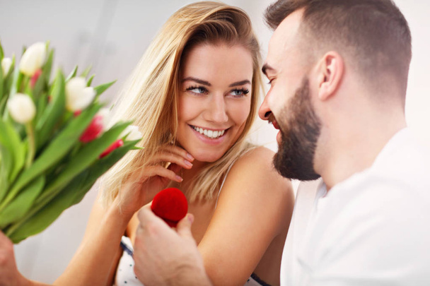 Adult attractive couple in bed with present - Photo, Image