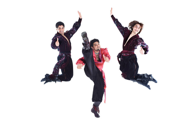 Gypsy trio of dancers in traditional dress performs folk dance - Фото, изображение
