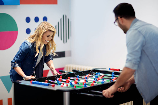 Friends having fun together playing table football - Foto, Imagem