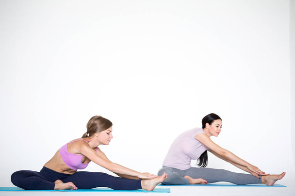 Women practicing yoga. - Fotó, kép