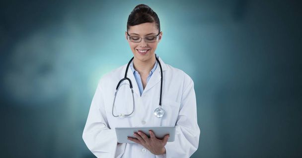 Digital composite of Female doctor holding tablet - Valokuva, kuva