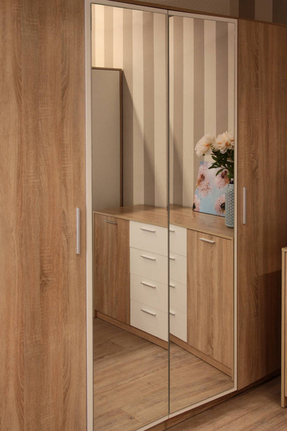 Facade of the wardrobe with a mirror in the bedroom. Interior - Photo, image