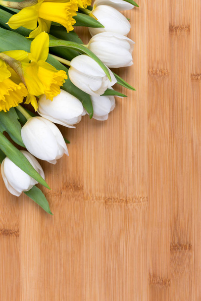 Easter background with fresh flowers on a wood board - Fotoğraf, Görsel