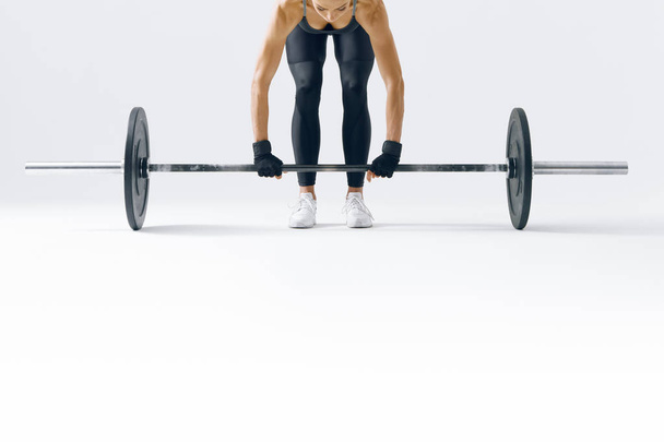 Fit young woman lifting barbell - Photo, Image