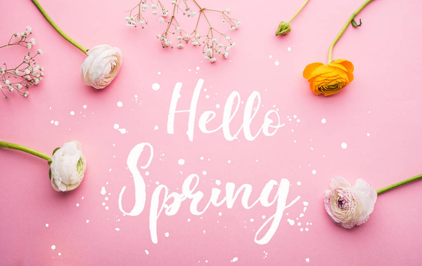 Hello spring phrase and flowers flat lay on a pink bacground. - Foto, Imagem