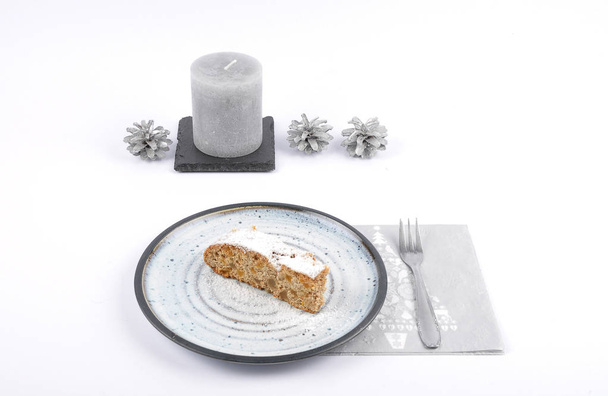 Christmas stollen on plate with christmas decoration - Foto, afbeelding