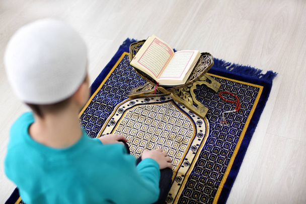 Little Muslim boy praying, indoors - Valokuva, kuva