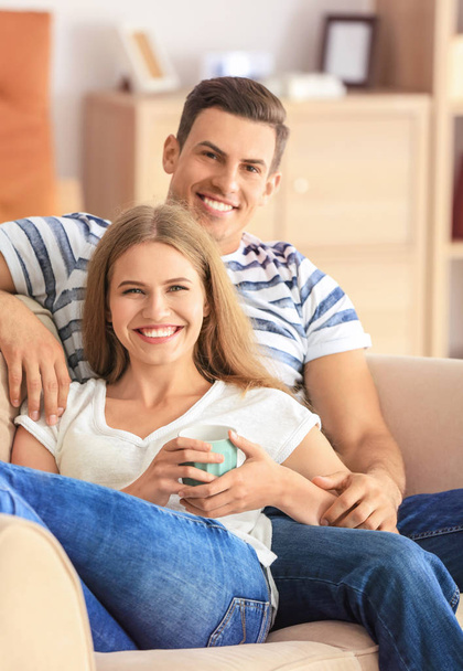 Young couple on sofa at home - Foto, Imagen