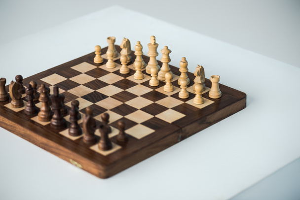Korkea kulma näkymä shakkilaudan chees kappaletta asetettu uuden pelin eristetty valkoinen
 - Valokuva, kuva