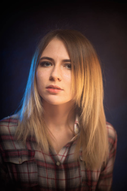 portrait smiling girl on blue background in studio - 写真・画像