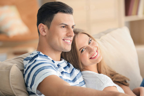 Young couple on sofa at home - Photo, Image