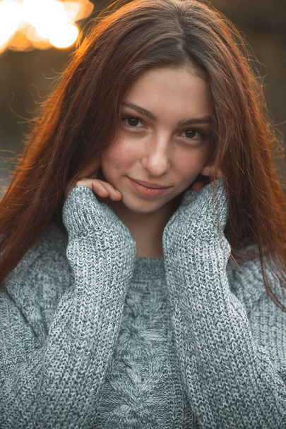 portrait of young woman with hands on neck - Foto, imagen