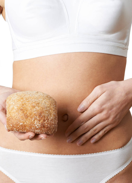 Close Up Of Woman Wearing Underwear Holding Bread Roll And Touch - Φωτογραφία, εικόνα