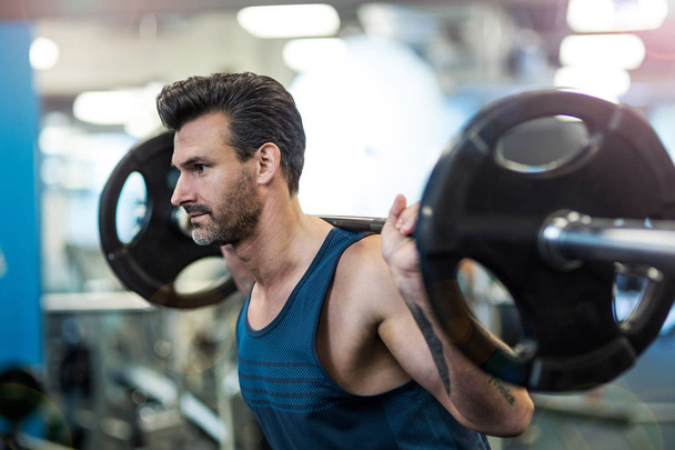 Man exercising in gym - Photo, Image