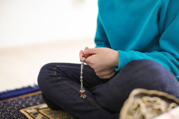 Little Muslim boy praying, indoors - Фото, зображення