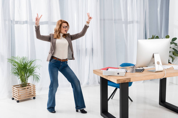 stylish businesswoman showing peace sign in office - Zdjęcie, obraz