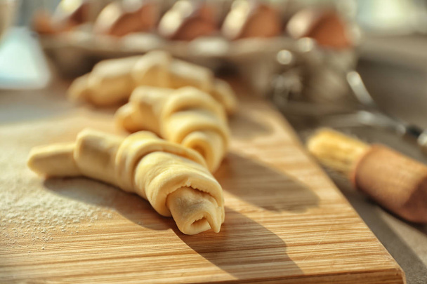 Wooden board with raw croissants, closeup - Photo, Image