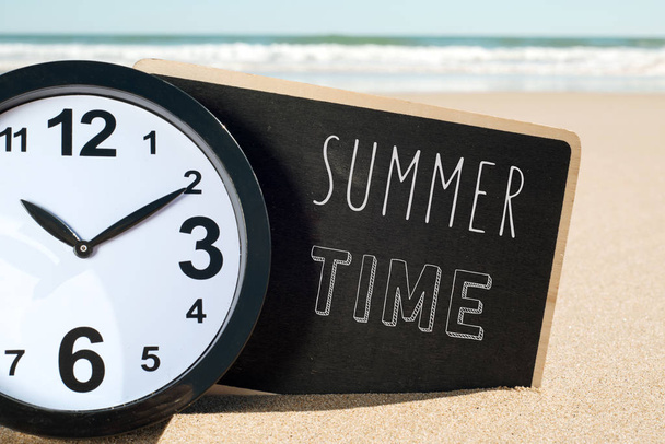 clock on the beach and text summer time - Photo, Image