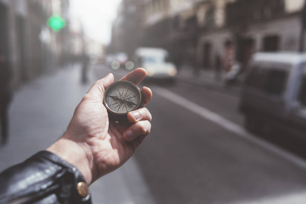 Hand of person holding compass in Madrid city - Photo, Image