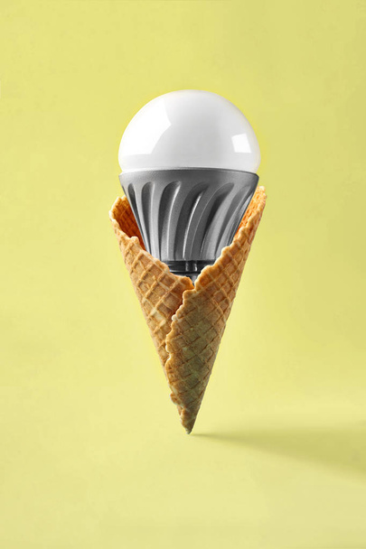 Led lamp in ice cream cone, innovation concept - Foto, afbeelding