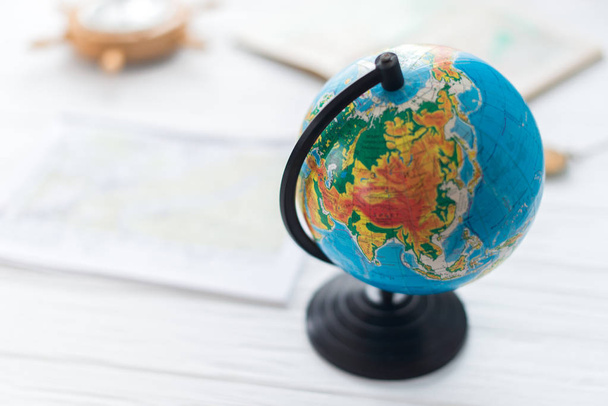 Globe on a wooden white background. The concept of travel - Foto, immagini