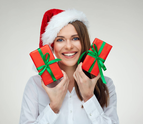 smiling businesswoman in Santa hat holding two red gifts  - Fotografie, Obrázek