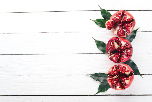 Pomegranate. On a white wooden background. Top view. Copy space. - Fotó, kép