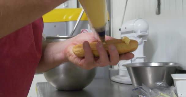 baker decorating pastries and cakes in bakery kitchen, professional business homemade desserts cream piping and chocolate icing sugary treats beautiful snacks unhealthy food - Materiaali, video