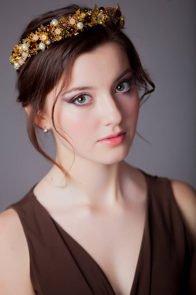 Young teen girl with beautiful wreath on grey background  - 写真・画像