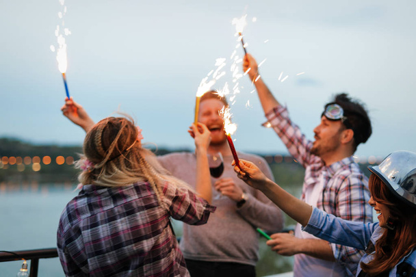 Group of happy friends celebrating at rooftop together - Fotoğraf, Görsel
