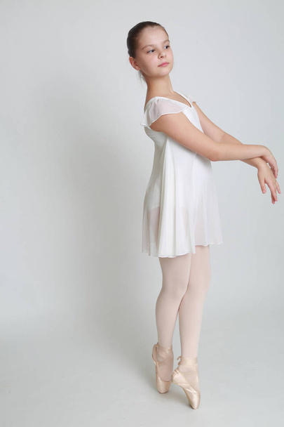 Beautiful little ballerina on pointe  in studio - Fotó, kép