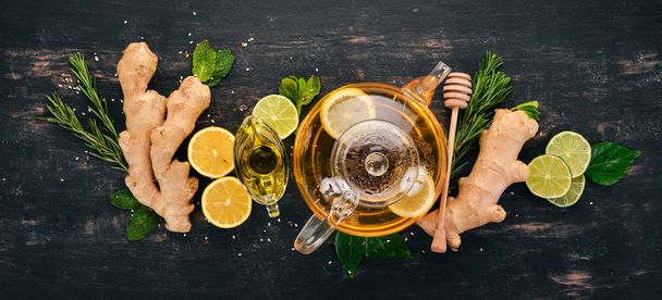 Tea with mint, ginger and lemon. Hot drink On a wooden background. Top view. Copy space. - Fotoğraf, Görsel